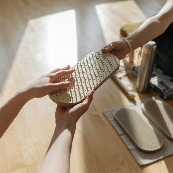 Person meditating peacefully in a bright, minimalist setting.